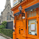 Victorian globe wall light in cast iron 1.05m in height with decorative arm.
