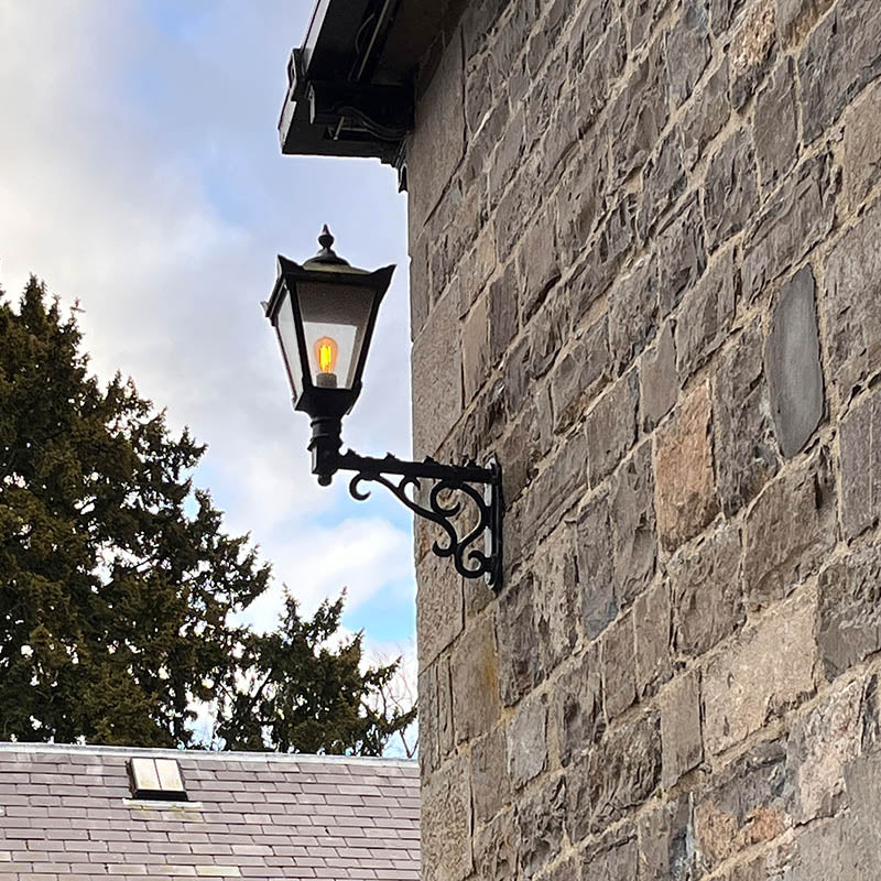 Victorian traditional cast iron wall light 0.97m in height with decorative arm.